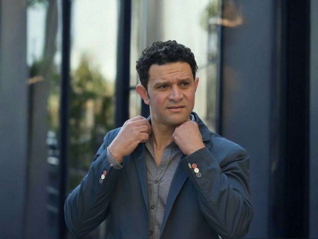 Portrait of a middle-aged European television presenter in a suit